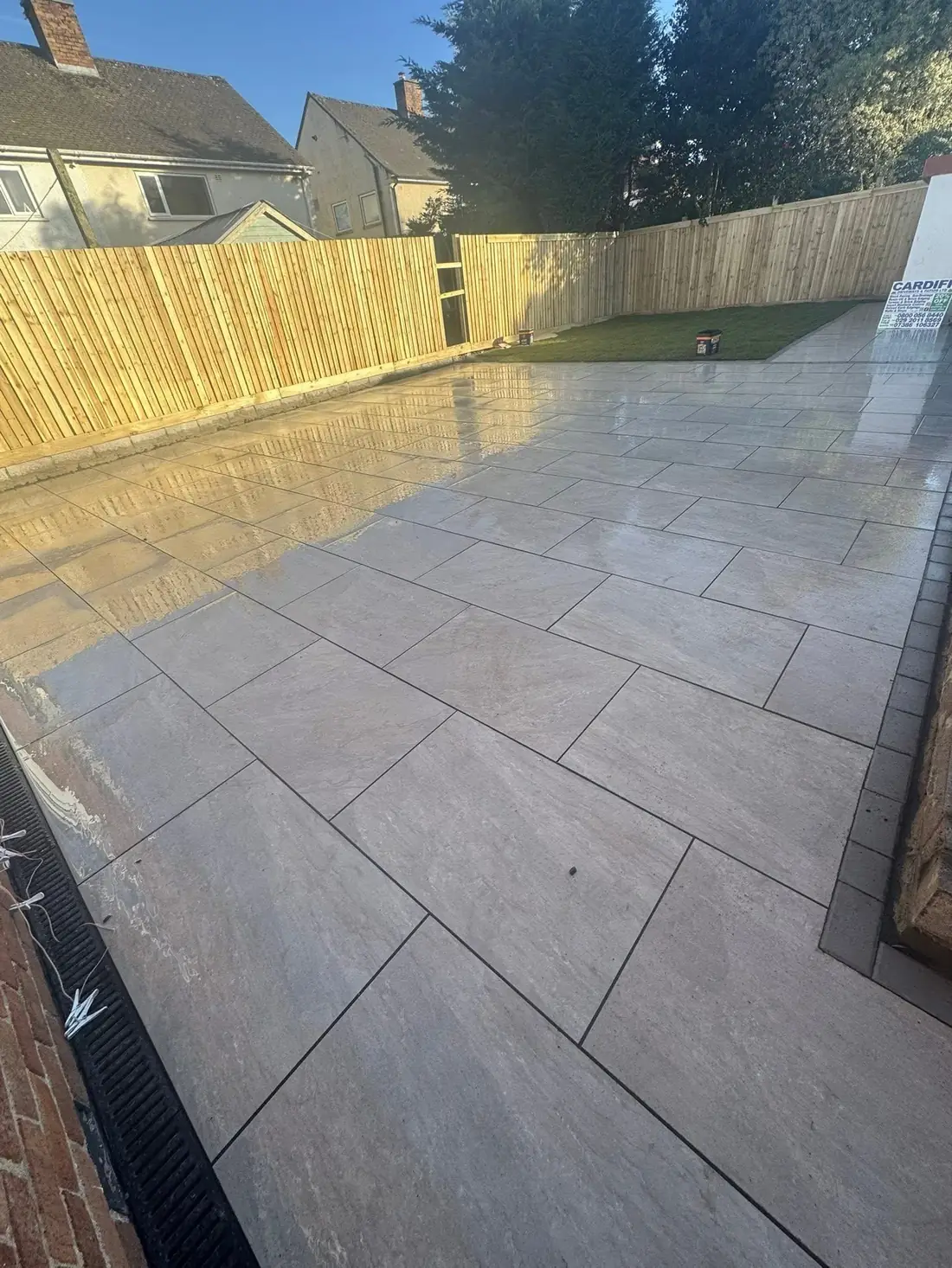 newly laid patio with porcelain tiles and timber fencing Burton