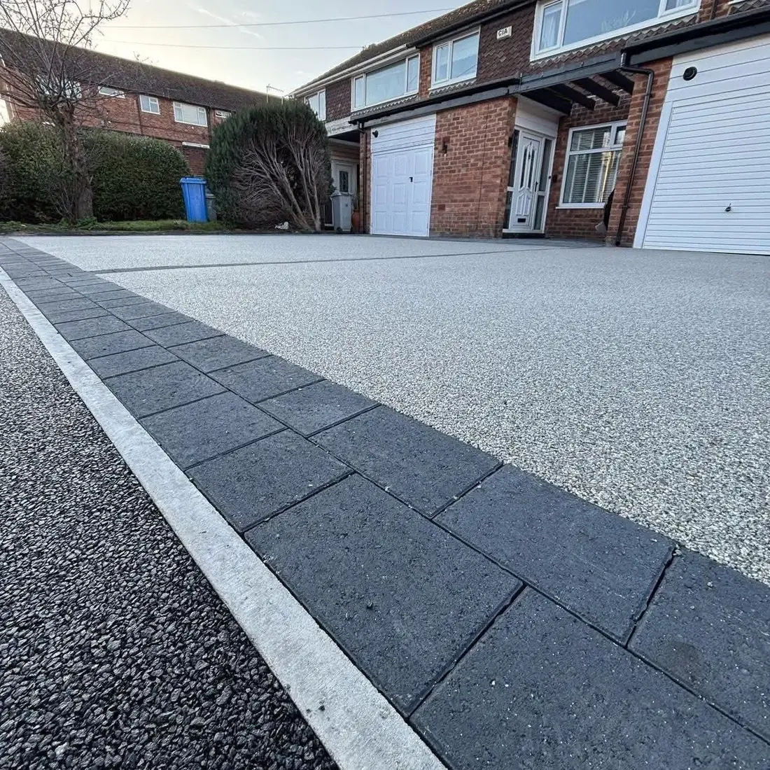 Resin bound driveway with dark block paving border Burton
